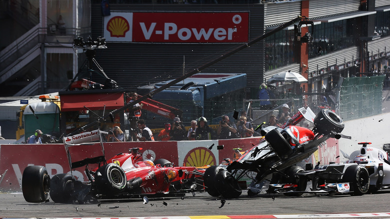 Three F1 cars colliding in the first lap of the 2012 Belgian Grand Prix