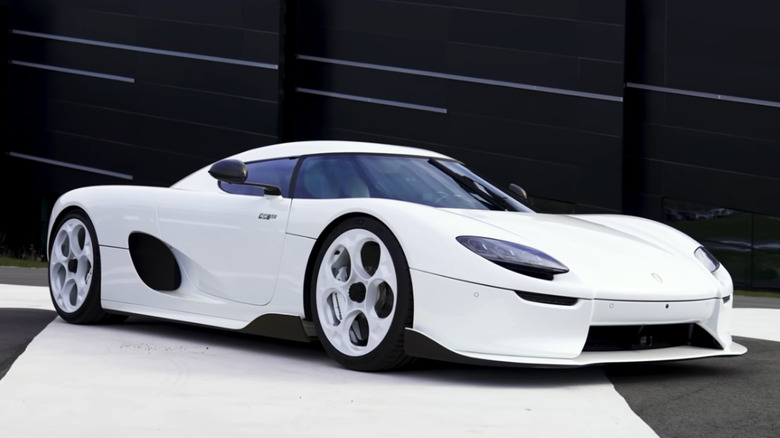 The front 3/4 of a white Koenigsegg CC850 in a studio