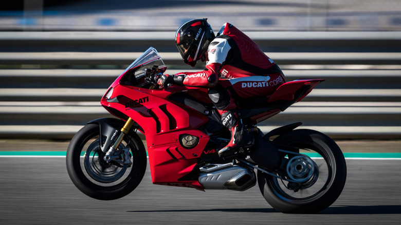 A rider doing a wheelie on track on the Ducati Panigale V4