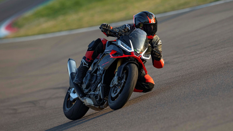 A red Aprilia Tuono V4 Factory 1100 on a track