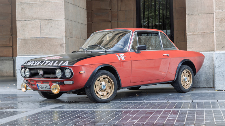 A Lancia Fulvia Coupe 1.6 HF parked by a building