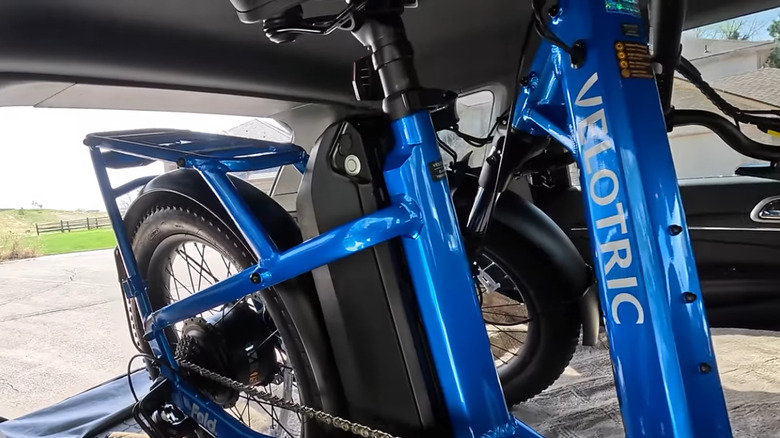 Folded up Velotric Fold 1e-bike in back of SUV