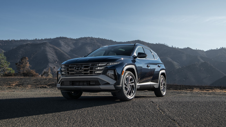 Front 3/4 view of a blue 2026 Hyundai Tucson Hybrid.