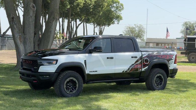 A multi-color 2027 Ram 1500 TRX SRT parked on a lawn.