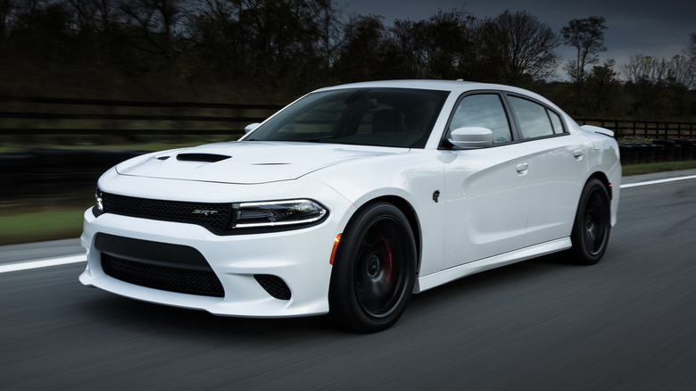 2015 Dodge Charger SRT Hellcat driving down a road with trees in the background
