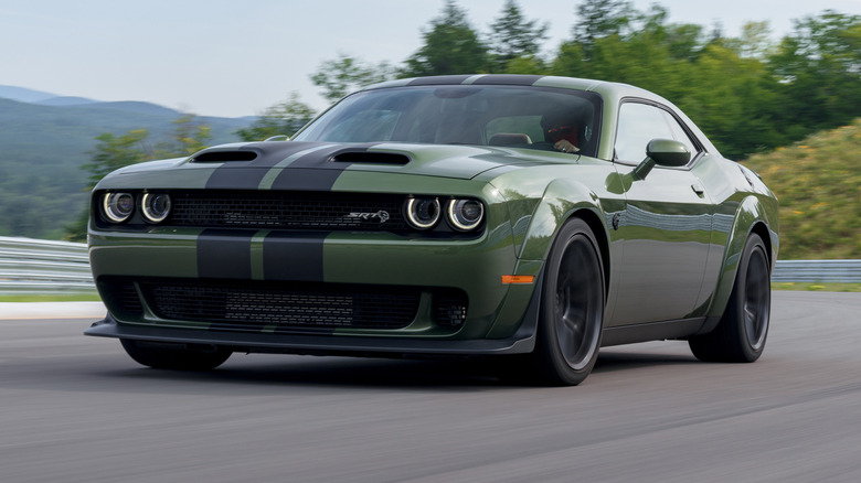 2019 Dodge Challenger SRT Hellcat Redeye Widebody driving down a road with trees and mountains in the background