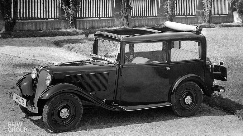 A black-and-white photo of a BMW 303 roll-top sedan