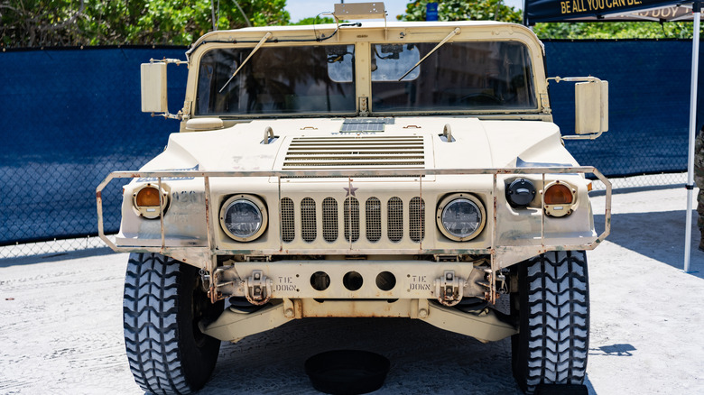 A front-end view of a desert Humvee military SUV.
