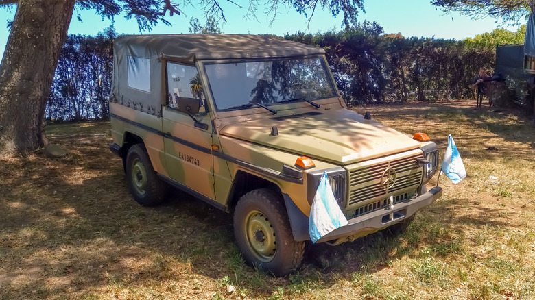 Green military 1970s Mercedes Benz Geländewagen parked on display.