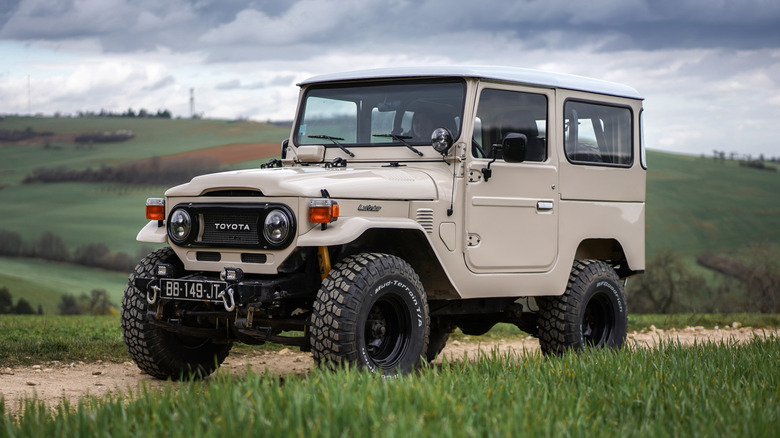 A Toyota BJ military SUV parked in a rural environment.