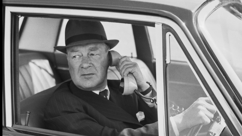 Man using a car telephone while driving.