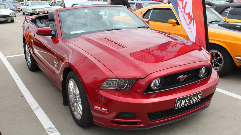 3/4 front view of a red 2013 Ford Mustang GT 5.0 Convertible