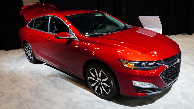 A red 2023 Chevy Malibu at an auto show