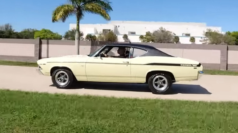 A 1969 Yenko Chevelle driving near a palm tree