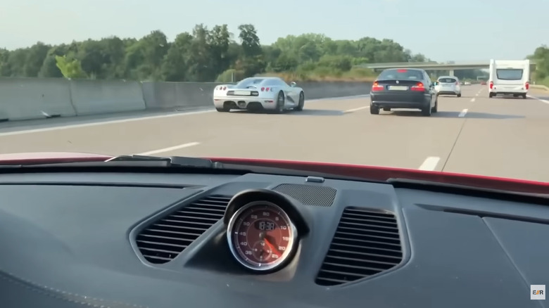 A silver supercar overtaking another car on the German Autobahn
