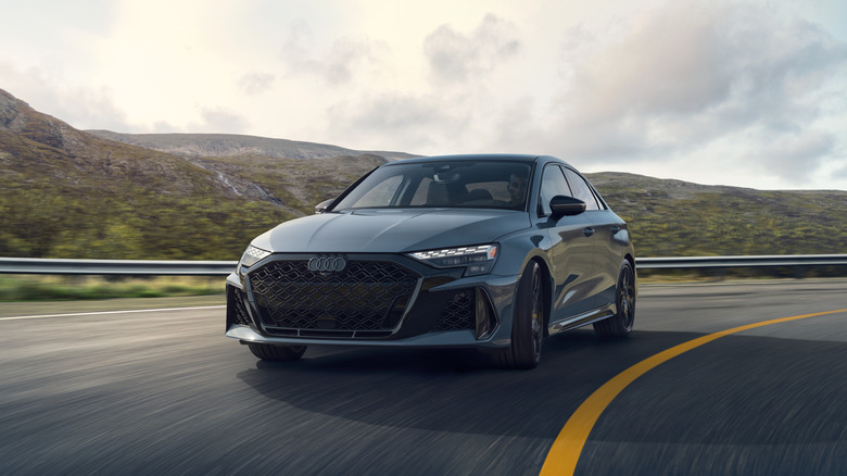 A gray 2026 Audi RS 3 on a curved roadway.