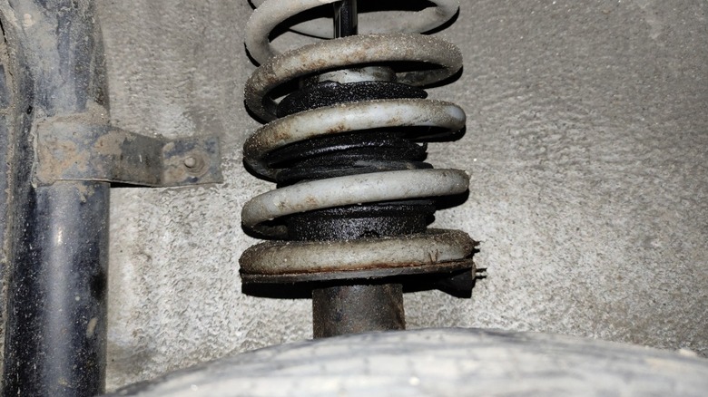 Broken shock absorber with signs of leaking