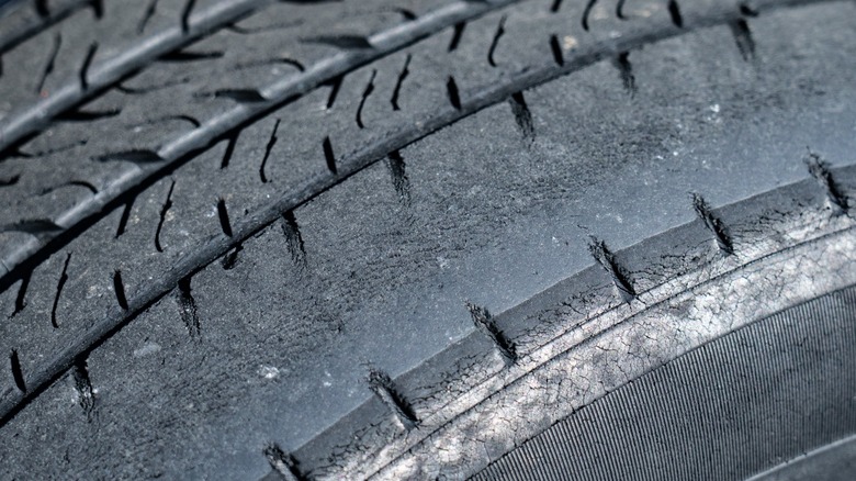 Tire with a worn out outside tread.