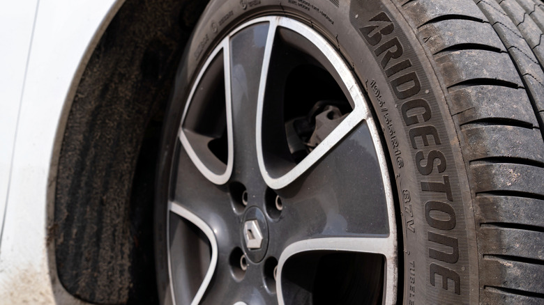 A close-up of a Bridgestone tire mounted on a rim on a car.