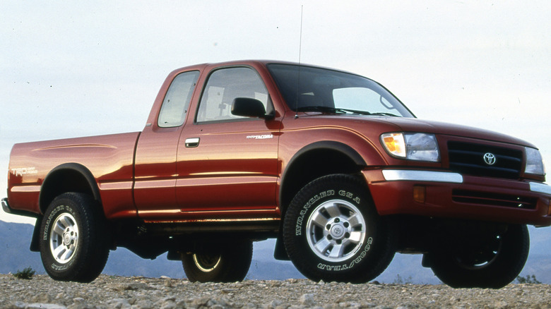 A red 1998 Toyota Tacoma on a hill.