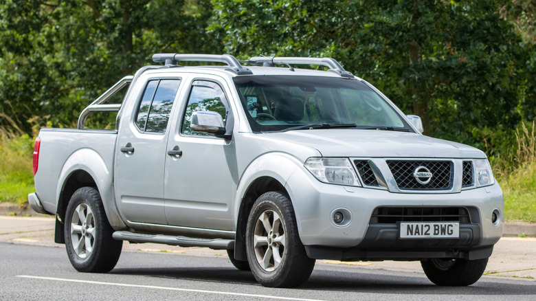 Front and side view of a gray Nissan pickup truck