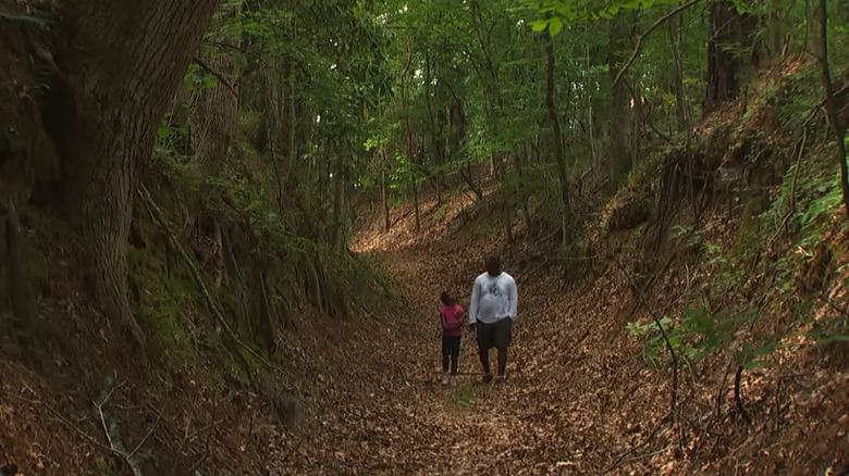 Father and daughter walking on the old Natchez Trace trail