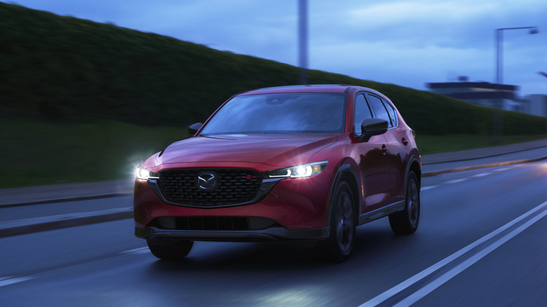 A red 2023 Mazda CX-5 on a roadway.