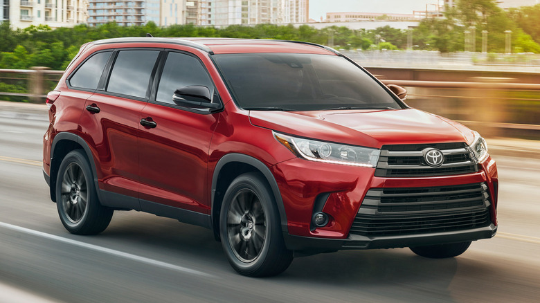 A red 2019 Toyota Highlander on a highway.