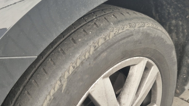 Tire worn unevenly with most wear on outer tread