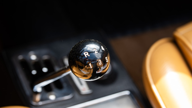 A close-up of an old Ferrari Dino manual transmission shifter.
