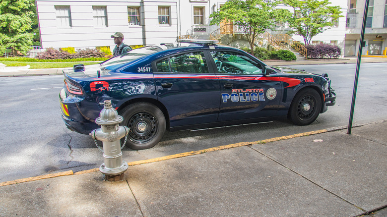 Atlanta, Ga USA - 06 07 20: Downtown Atlanta police car side view and officer on side