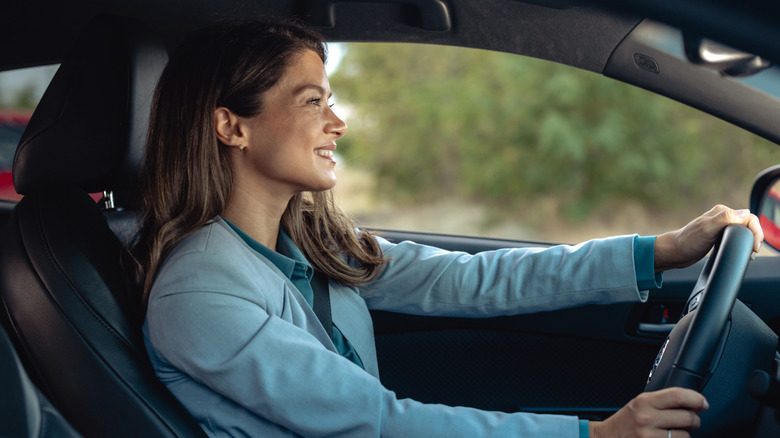 A happy customer driving a car