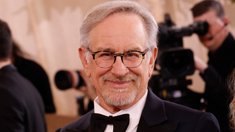 Steven Spielberg looking dapper wearing a black bow-tie and glasses at an event.