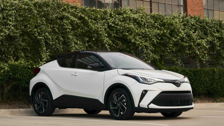A white 2022 Toyota C-HR in front of a building
