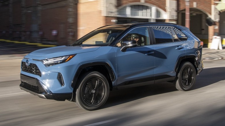 A blue 2022 Toyota RAV4 being driven on a street