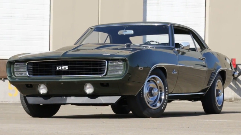 A dark green 1969 Chevrolet Camaro RS COPO ZL1 with cowl-induction hood and concealed headlights.