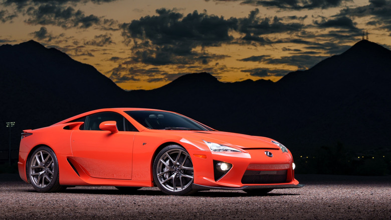 An orange Lexus LFA is displayed in front of mountains.