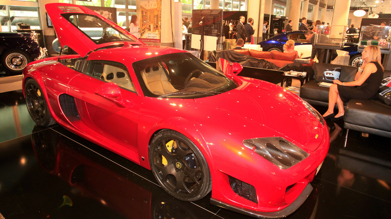 A silver Noble M600 speeds along the road.