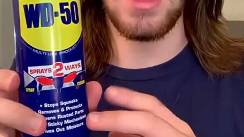 Close up of many holding can of WD-50