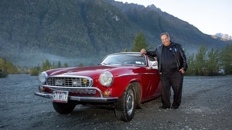 Irvin Gordon standing next to his Volvo P1800 after clocking 3 million miles near Anchorage, Alaska