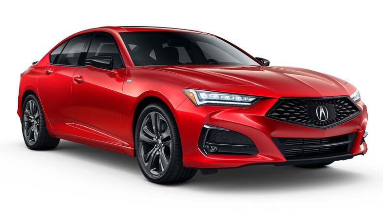 A red 2023 Acura TLX against a white background.