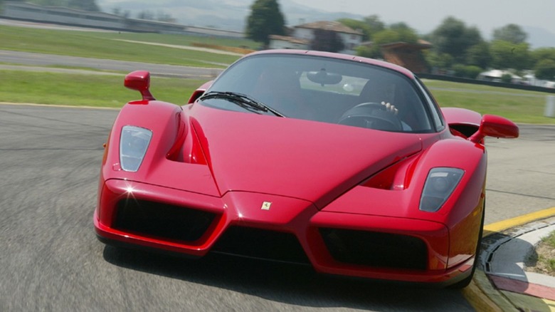 Front shot of a Ferrari Enzo driving on track