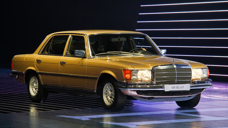 A Mercedes-Benz 450 SEL 6.9 under bright indoor lighting