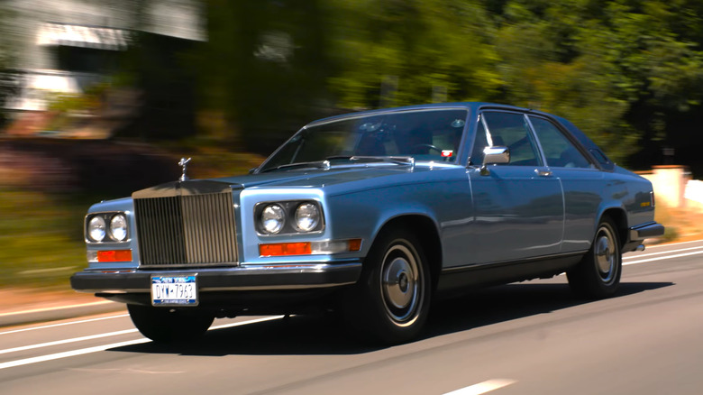 A rolling shot of a light blue Rolls-Royce Camargue