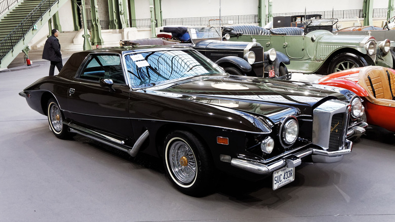 A black 1977 Stutz Blackhawk in auction setting