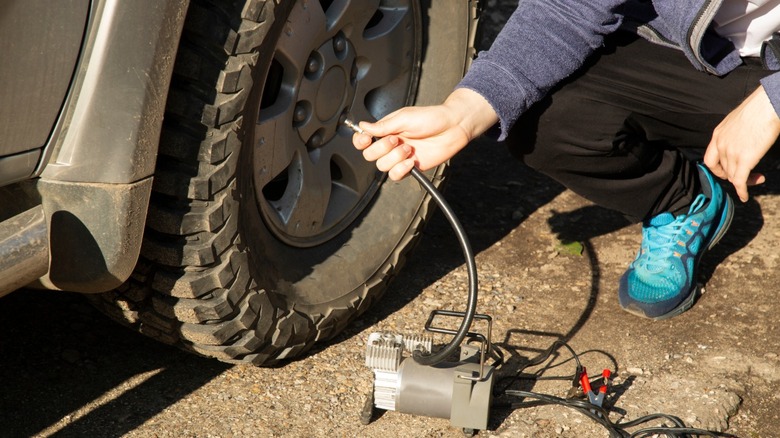 Person inflates a tire.