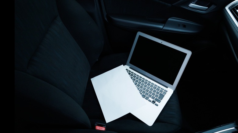 Small grey laptop left on car seat.
