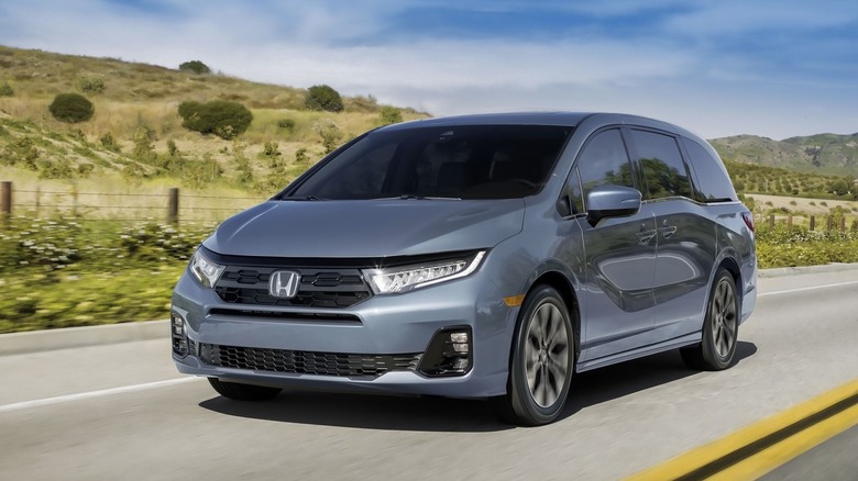 A front 3/4 view of a blue 2026 Honda Odyssey in motion.