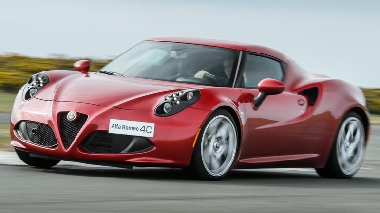 A red Alfa Romeo 4C driving on a track in Ireland