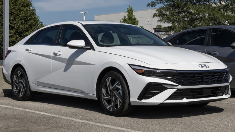 A white Hyundai Elantra in a parking lot.